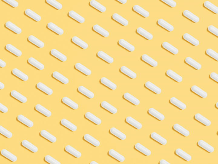While pills on yellow background