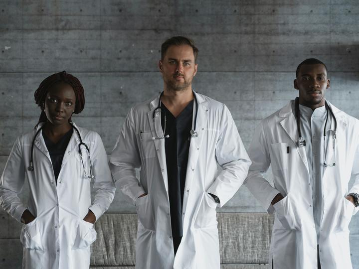 Three Doctors Wearing Medical Gowns
