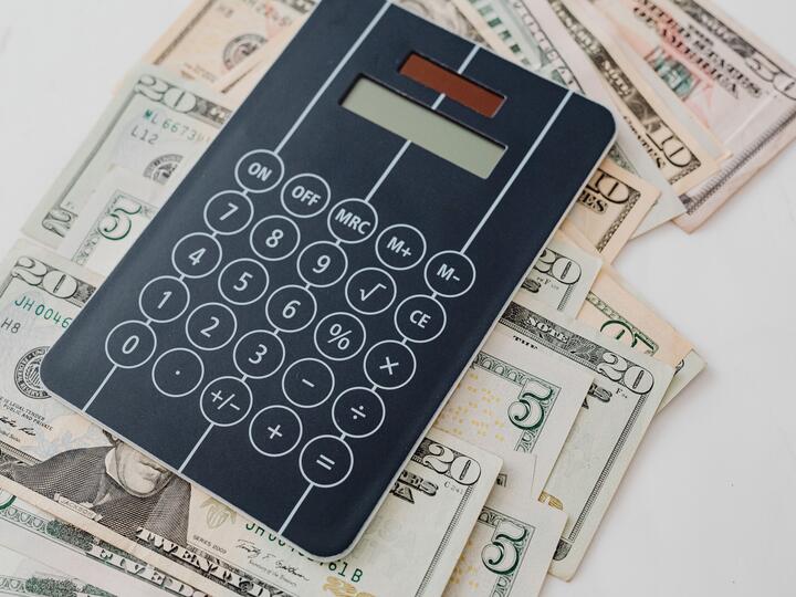 Calculator atop US dollar bills