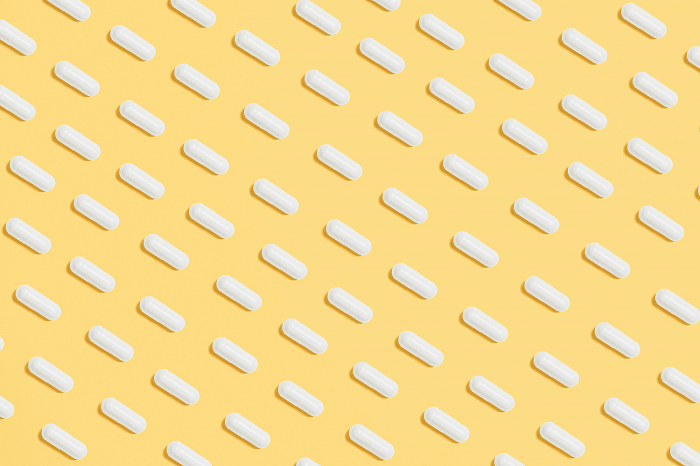 While pills on yellow background